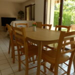 Bright dining room with large table overlooking the garden in a French host family home.