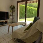 Comfortable living room with large windows overlooking the garden in a French host family home.
