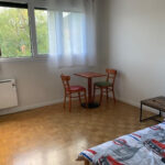 Private student bedroom with single bed, desk and natural light in a host family home in Eybens.