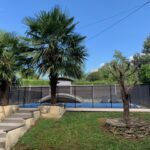 Private garden with swimming pool and mountain views at a welcoming host family home in Murianette near Grenoble.