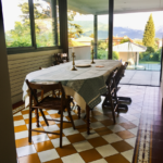 Bright dining room with large family table overlooking the mountains.